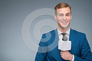 Smiling newsman holding a microphone