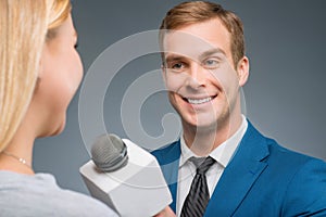Smiling newsman taking an interview