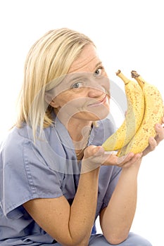 Smiling nurse doctor healthy ripe bananas