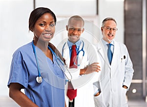 Smiling nurse in front of her medical team