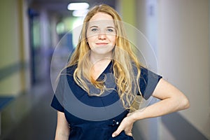 Smiling nurse in hospital hallway