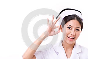 Smiling nurse making ok hand gesture