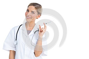 Smiling nurse preparing syringe