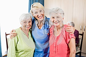 Smiling nurse and senior women standing