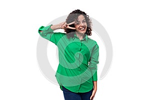 smiling office brunette woman with curly hair dressed in a green shirt on a white background