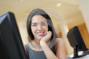 Smiling office worker in front of computer