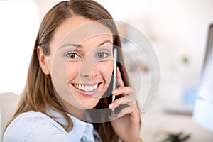 Smiling office worker talking on phone photo