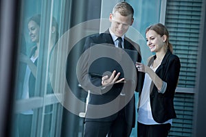 Smiling office workers using laptop