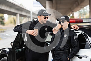 Smiling officer of police in sunglasses