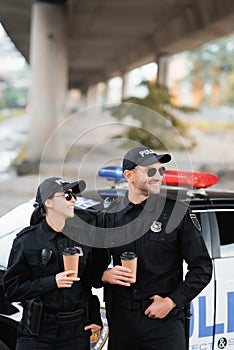 Smiling officers of police in sunglasses