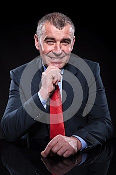 Smiling old business man thinking