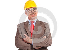Smiling old construction engineer looking up to his side