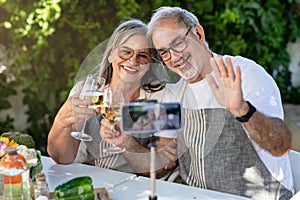 Smiling old european man, lady in aprons take selfie in garden