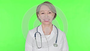 Smiling Old Female Doctor on Green Background