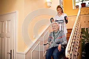 Smiling old lady, happy while nurse helps her to climb to the st
