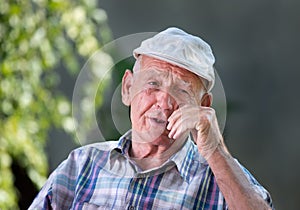 Smiling old man in courtyard