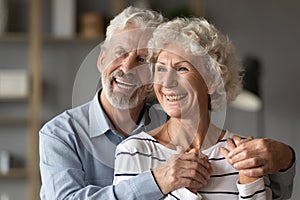 Smiling old middle aged bonding family couple looking in distance.