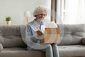 Smiling older female client satisfied with fast courier delivery service.