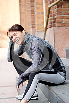 Smiling older sports woman resting outside