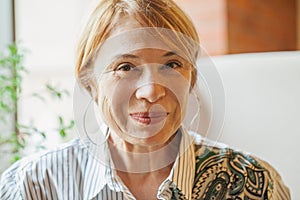 Smiling older woman with short ginger hair portrait