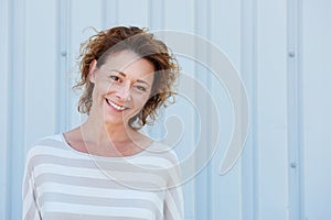 Smiling older woman standing outside