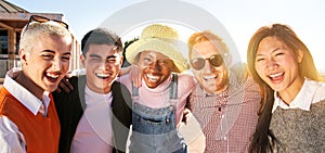 Smiling panoramic portrait of cheerful group of young people. Happy friends excited having fun. Interracial