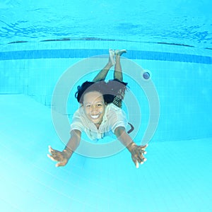 Smiling Papuan woman swimming in pool