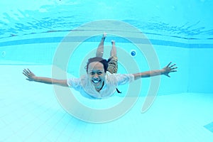 Smiling Papuan woman swimming in pool