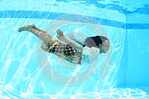 Smiling Papuan woman swimming in pool