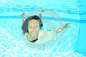 Smiling Papuan woman swimming in pool