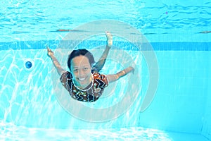 Smiling Papuan woman swimming in pool in brown dress