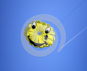 Smiling paragliding over the blue sky