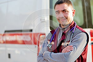 Smiling paramedic on ambulance machine background