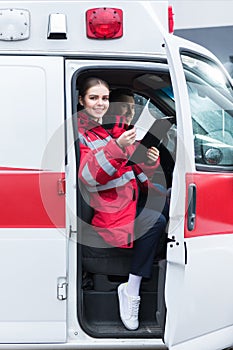 smiling paramedic sitting in ambulance