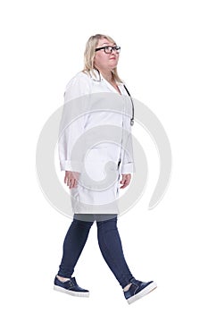 smiling paramedic in a white coat striding forward .