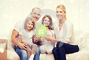 Smiling parents and two little girls at new home