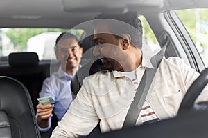 smiling passenger giving money to taxi car driver