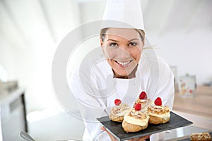 Smiling pastry chef with deserts