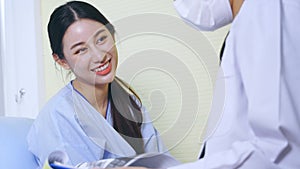 Smiling patient talking to doctor