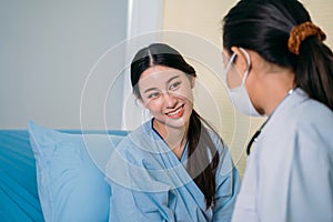Smiling patient talking to doctor