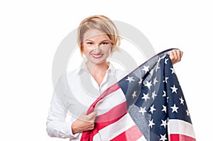 Smiling patriotic woman holding United States flag. USA celebrate 4th July.