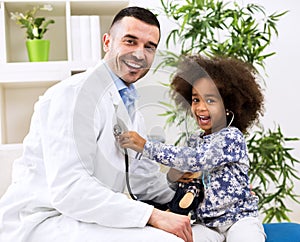 Smiling pediatrician and his happy little patient