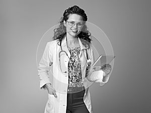 Smiling pediatrist woman using tablet PC on