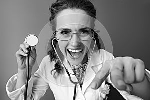 Pediatrist woman with stethoscope distracting child playing photo