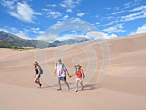 Smiling people on a hiking trip in mountains.