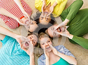 Smiling people lying down on floor and screaming