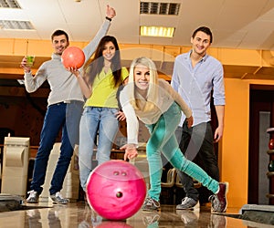 Smiling people playing bowling