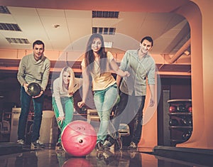 Smiling people playing bowling