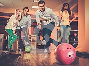Smiling people playing bowling