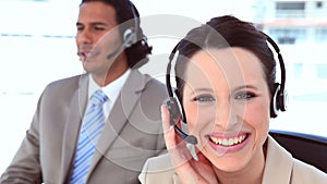 Smiling people in suit using headsets